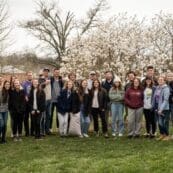 Group of students standing with trees in bloom