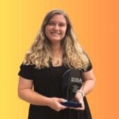 Gracie Turner ’23 holding an award