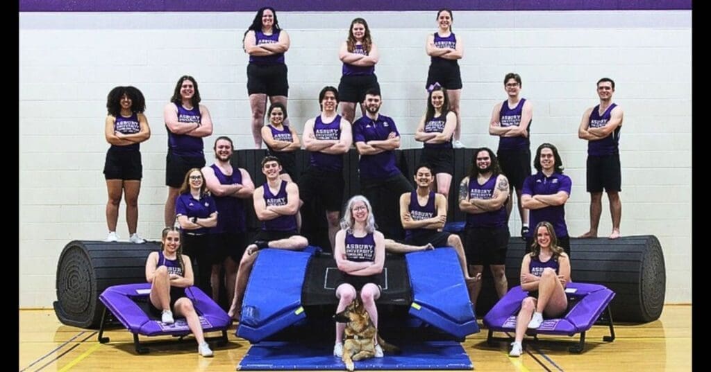Tumbling team posing on equipment