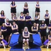 Tumbling team posing on equipment