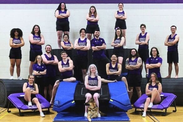 Tumbling team posing on equipment