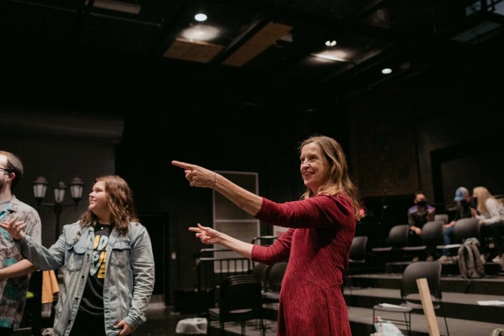 Asbury faculty member works with theatre students inside the black box theatre