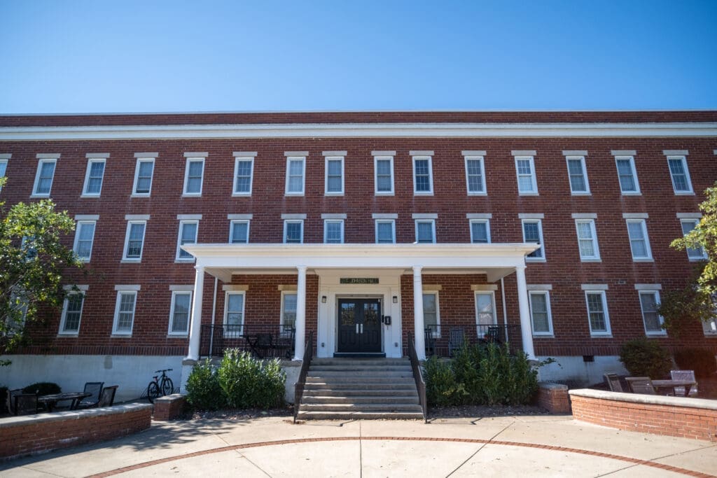 Front view of Johnson Men’s Residence Hall at Asbury University, a red brick building with white trim.