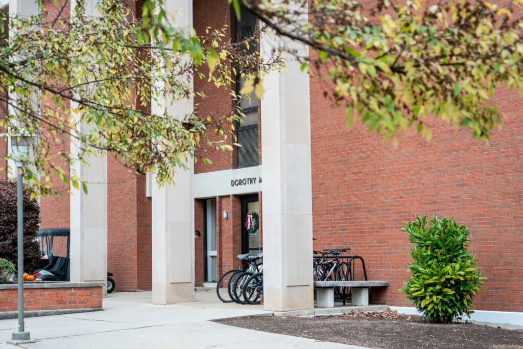 Side exterior view with trees blocking full view of Kresge Hall on the campus of Asbury University.