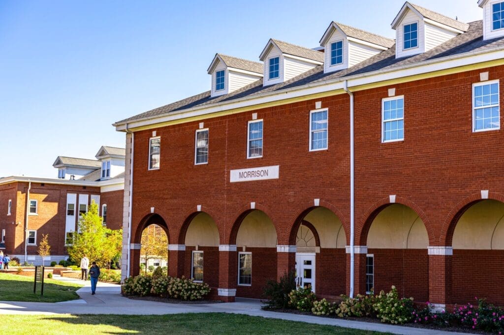 Side entrance of Reasoner Hall at Asbury University featuring a graceful rounded arcade.