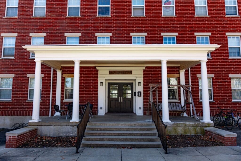 Front view of Trustees Men’s Residence Hall at Asbury University, a red brick building with white trim.