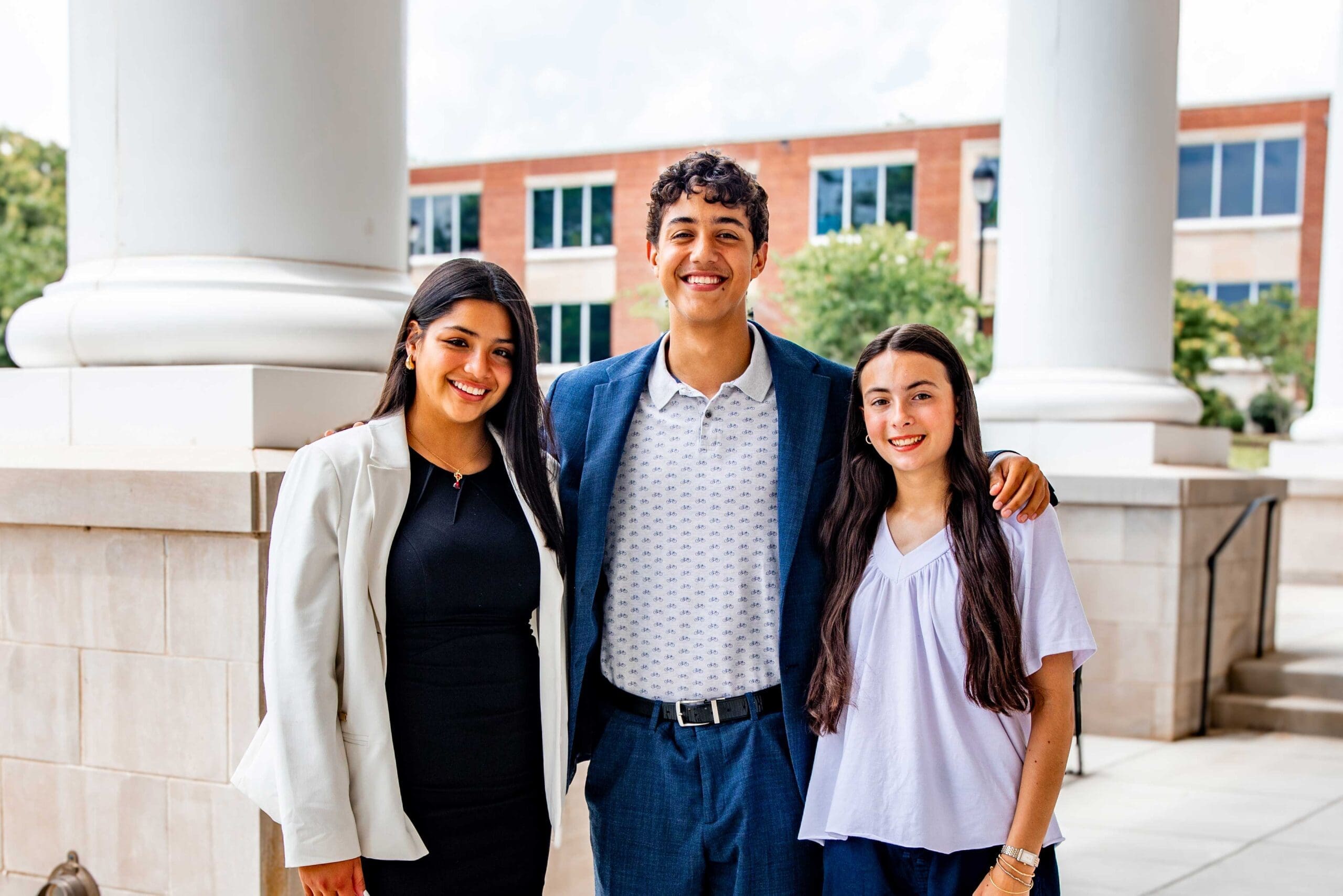 Three Asbury Dayton School of Business students standing together.