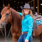 Asbury University alumna Clara Quade ’20 standing beside her horse Ruby after Central Ohio Reining Horse Association named her the 2025 Rookie Professional Champion.