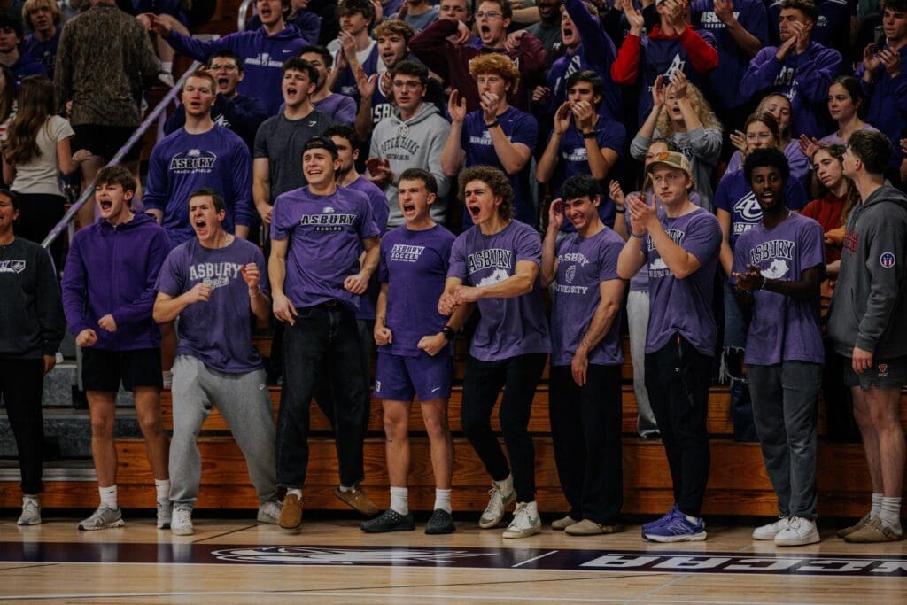 Asbury University student section cheering at an athletic event.