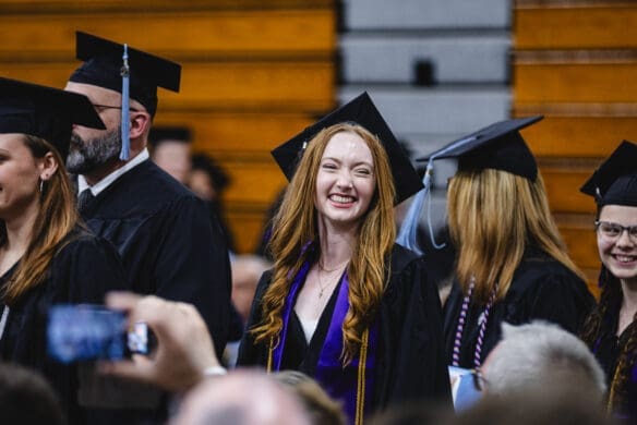An Asbury University athlete smiles at Commencement