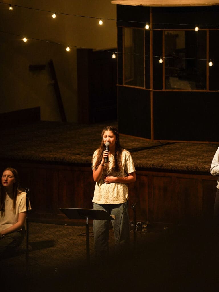 Annaliese Zonio worshiping in Hughes Auditorium at Asbury University