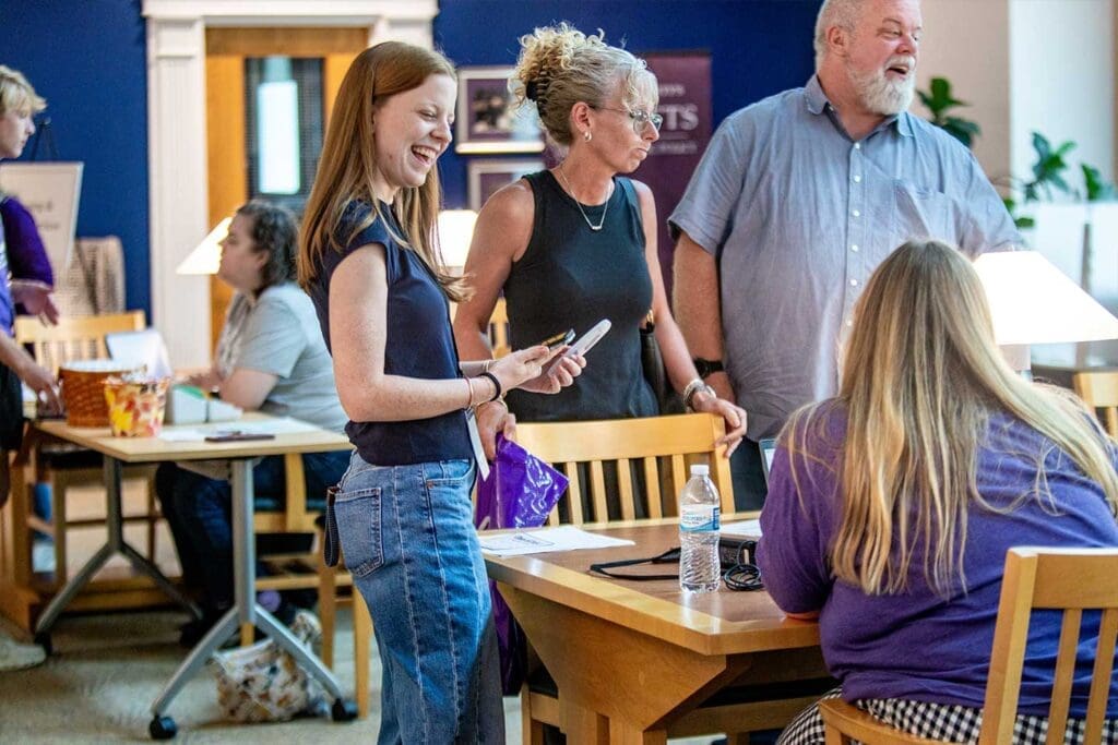 Mother, Father and daughter at Asbury's Eagle Days talking with staff.
