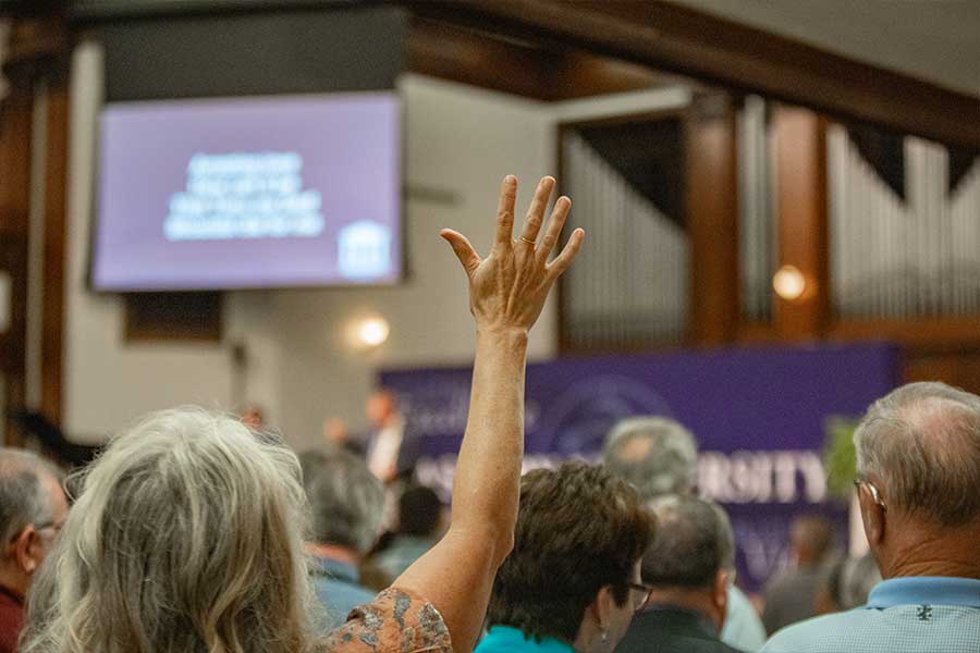 Woman's hand up and praising at hymn sing at Reunion at Asbury.