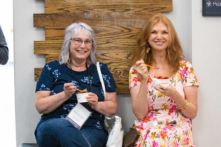 Two women enjoying ice cream at Asbury's Reunion.