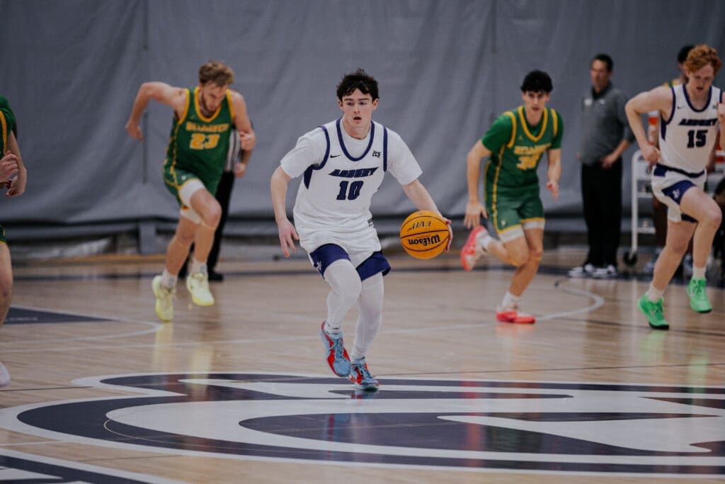 Asbury Athletics basketball player dribbles the basketball