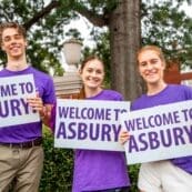 Asbury students holding Welcome to Asbury signs