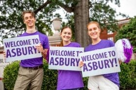 Asbury students holding Welcome to Asbury signs