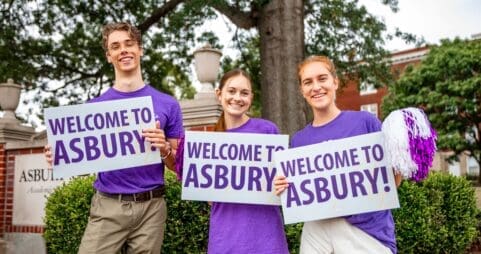 Asbury students holding Welcome to Asbury signs