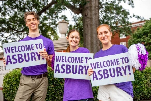 Asbury students holding Welcome to Asbury signs