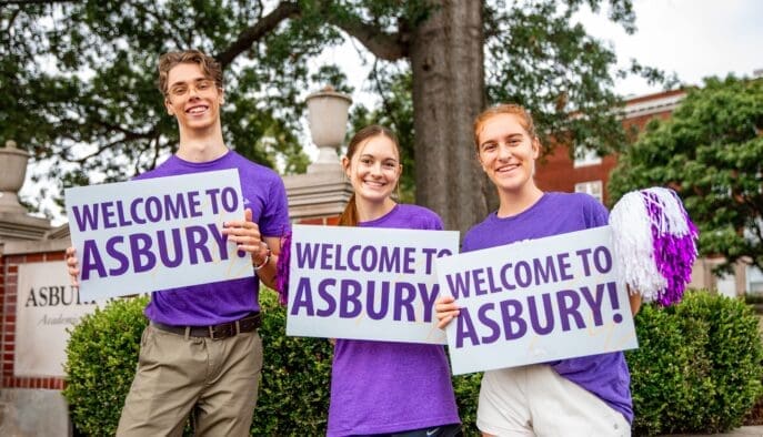 Asbury students holding Welcome to Asbury signs