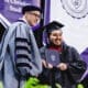 Asbury University President Dr. Kevin Brown smiles with graduating student at Commencement