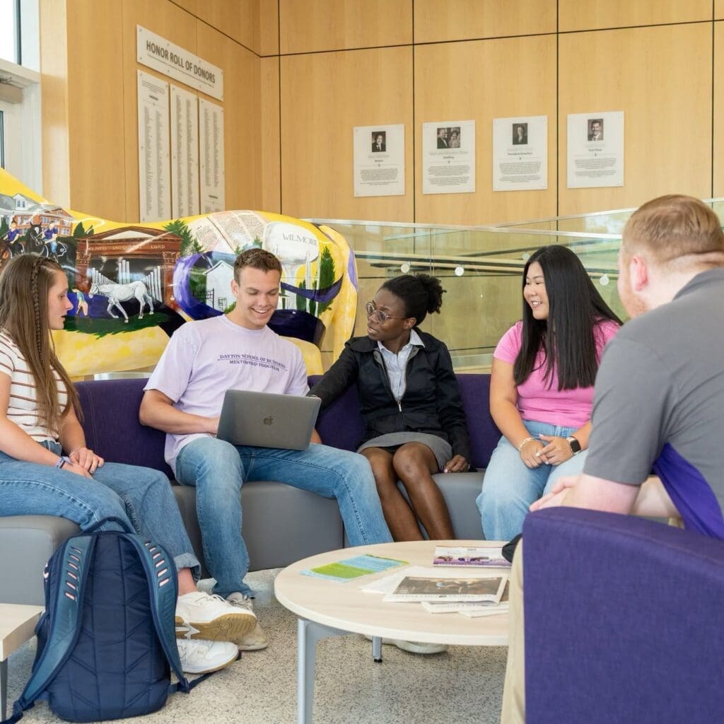Dr. Tolu Bewaji sits with Asbury Business students,