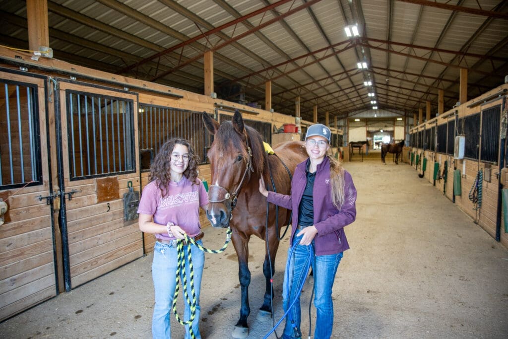 Asbury Equine students smile with horse