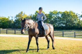 Asbury equine professor Cathrin Wilbanks rides a horse