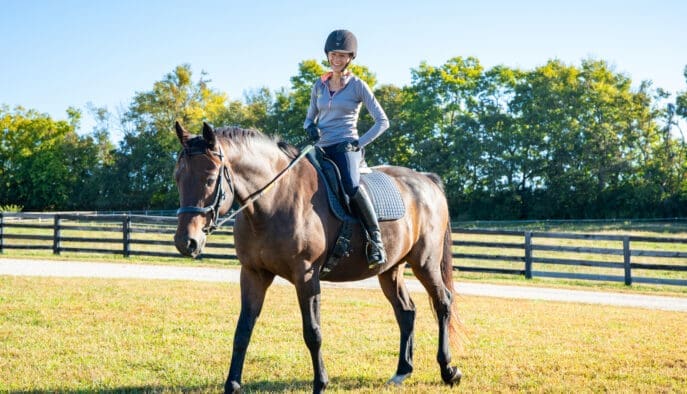 Asbury equine professor Cathrin Wilbanks rides a horse