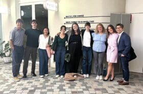 Asbury's Rob Lim stands with business internship students