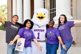 Asbury students cheer with Isaiah the Eagle