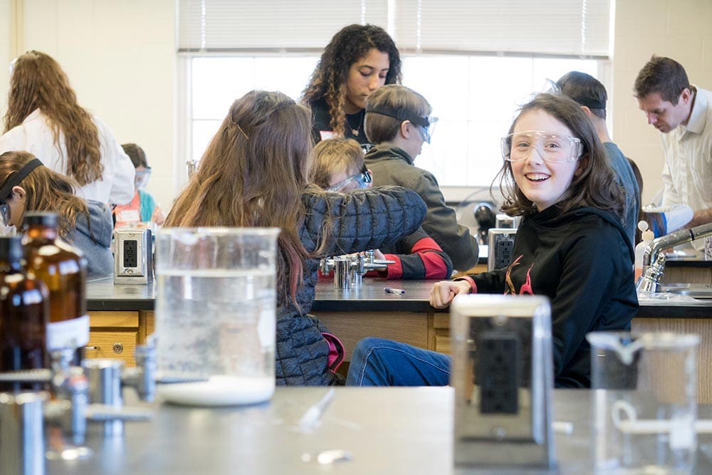 smiling kids doing science experiments