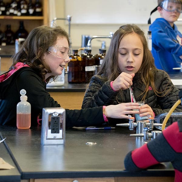 Two girls conducting a science experiment