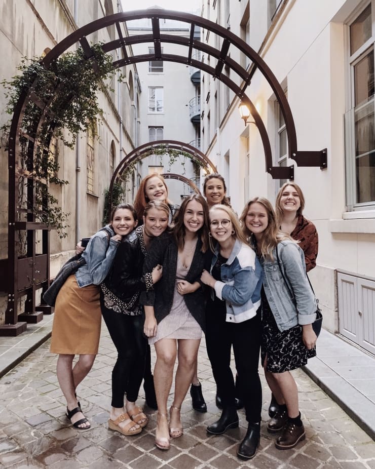 Students gathering under an arch