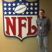 Ty Schadt ’20 standing beside the NFL logo