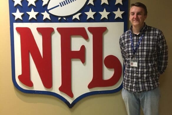 Ty Schadt ’20 standing beside the NFL logo