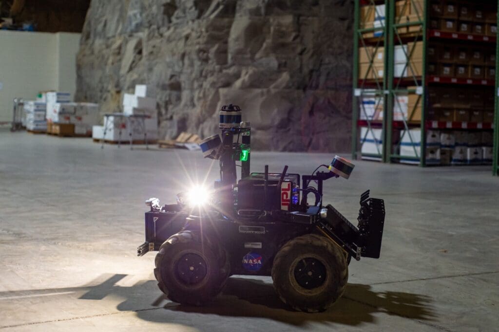 A four-wheeled robot driving on a concrete floor