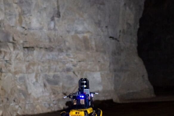 A four-legged robot walking through a cave