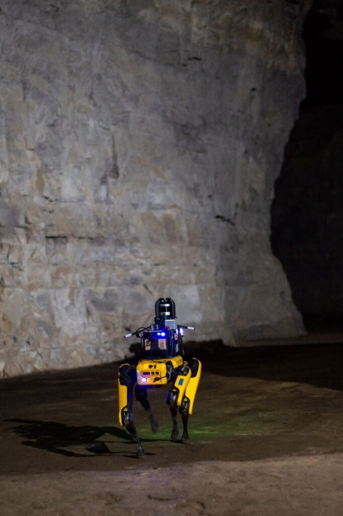 A four-legged robot walking through a cave