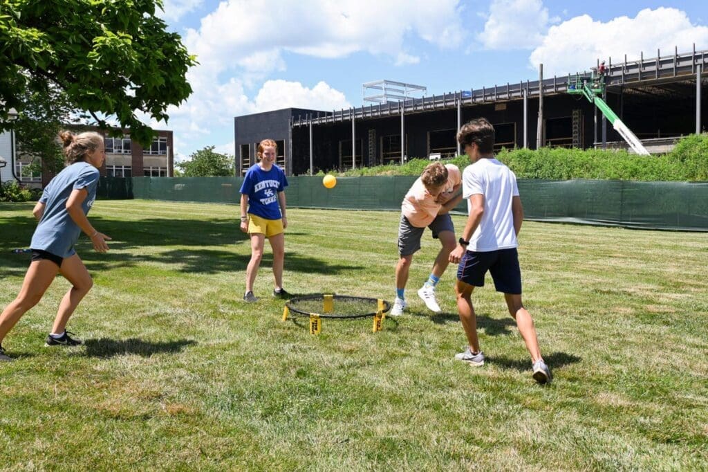 Students playing roundnet on the green