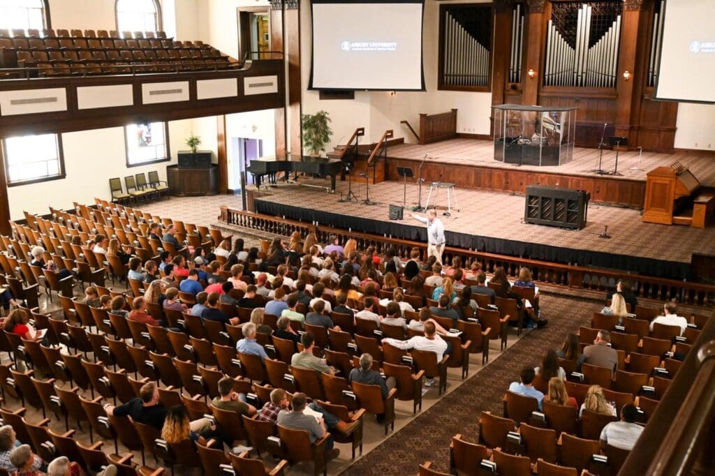 People listening to a presentation in Hughes Auditorium