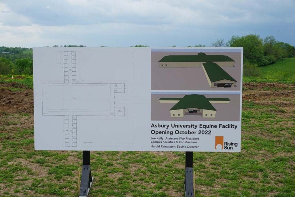 Outdoor sign showing floorplan and renderings of the new facility