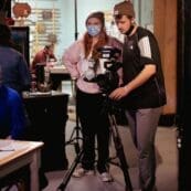 Students filming on a set