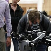 Student looking through microscope equipment