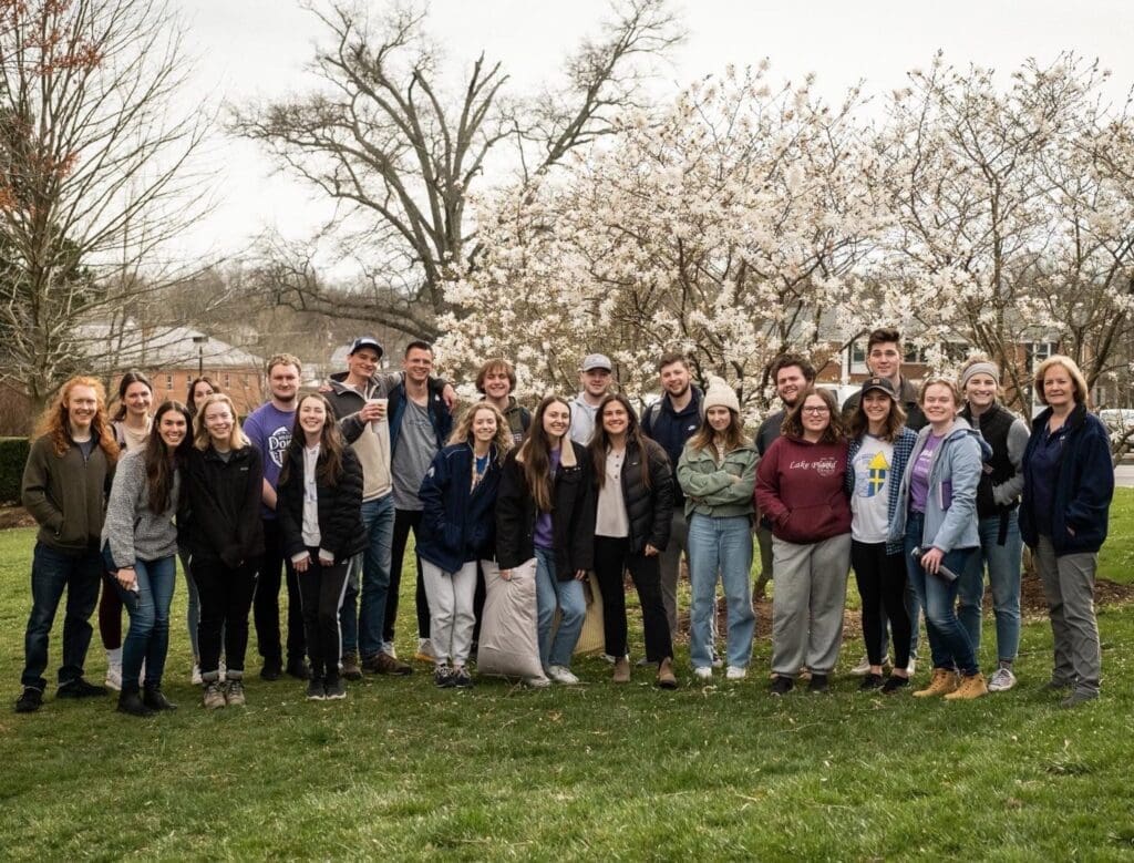 Group of students standing with trees in bloom