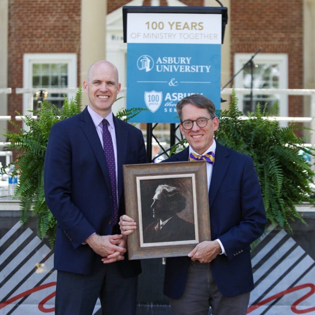 Dr. Kevin Brown and Dr. Timothy Tennent holding a portrait together