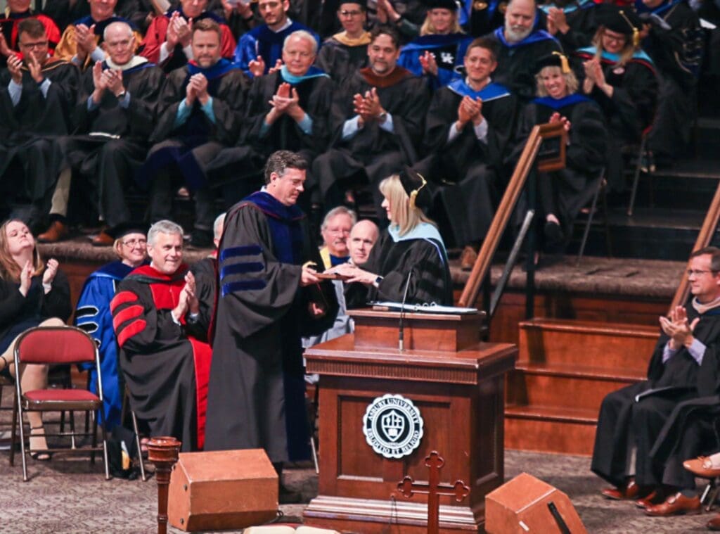 Dr. Strait receiving an award on stage