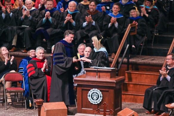 Dr. Strait receiving an award on stage