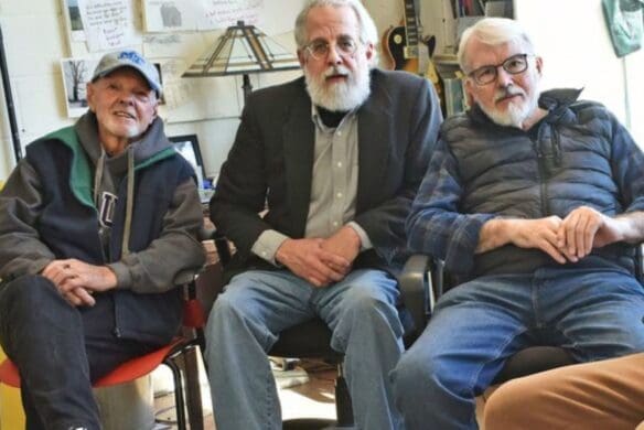 Three old men sitting in chairs