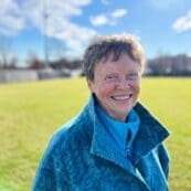 Carol Sue Ray '67 standing on a soccer field